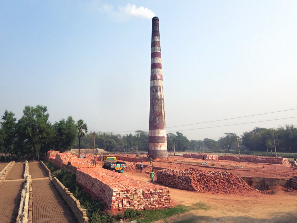 A brick kiln chimney and drying yard
